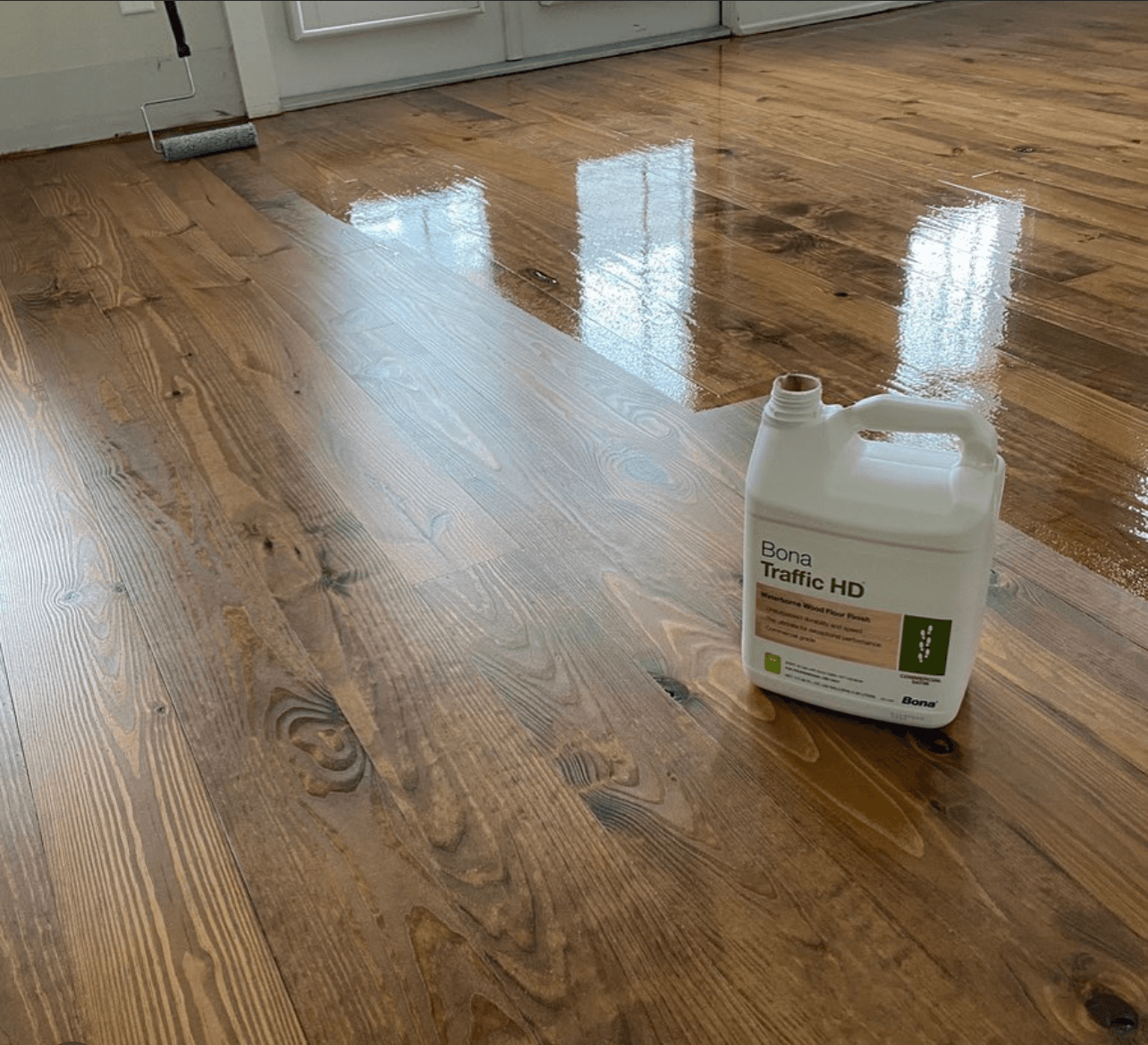 Bona Traffic HD finish being applied to pine hardwood floor with roller Clayton NC