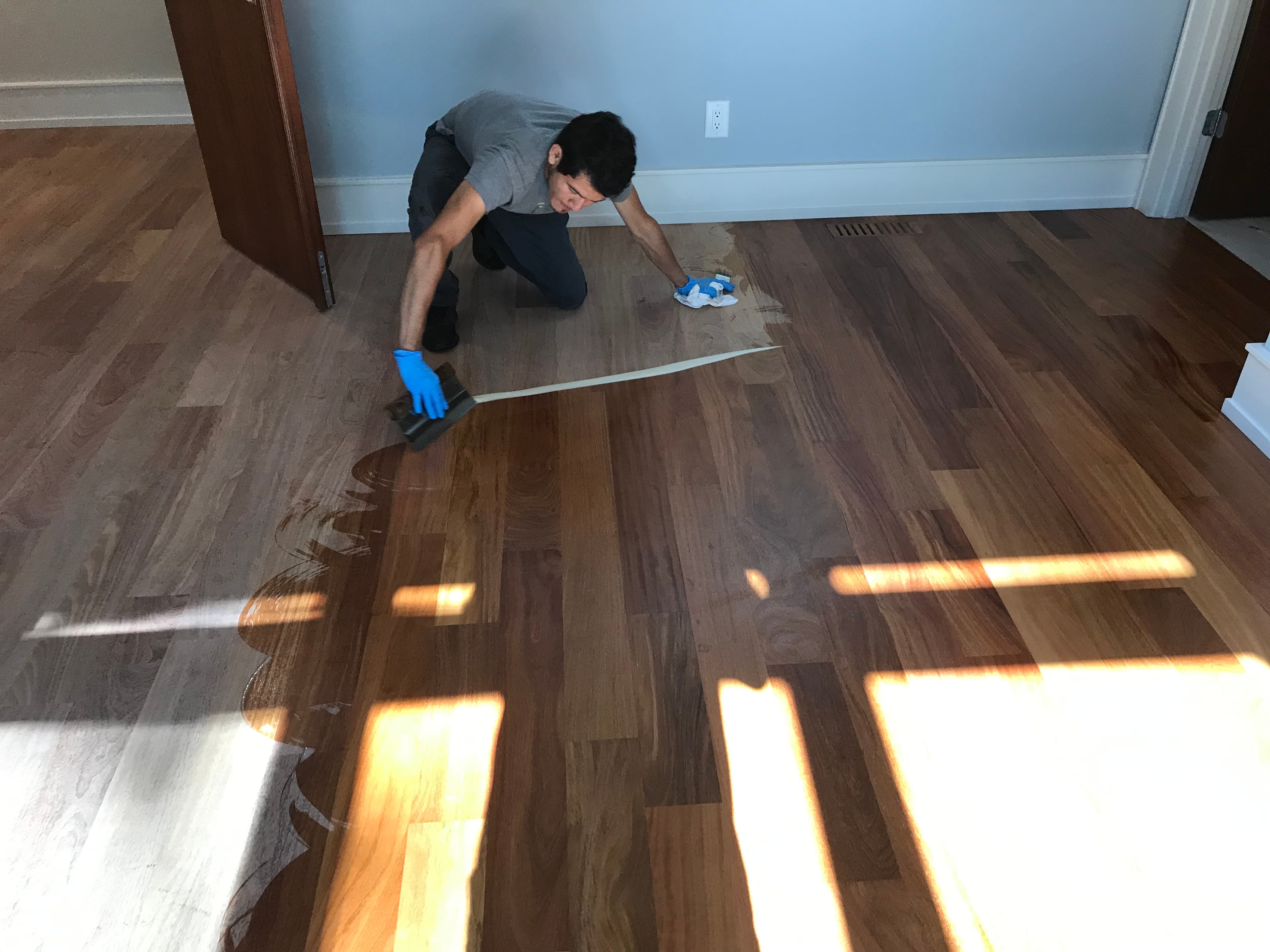 crew member applying hardwax oil finish to hardwood floor Clayton NC