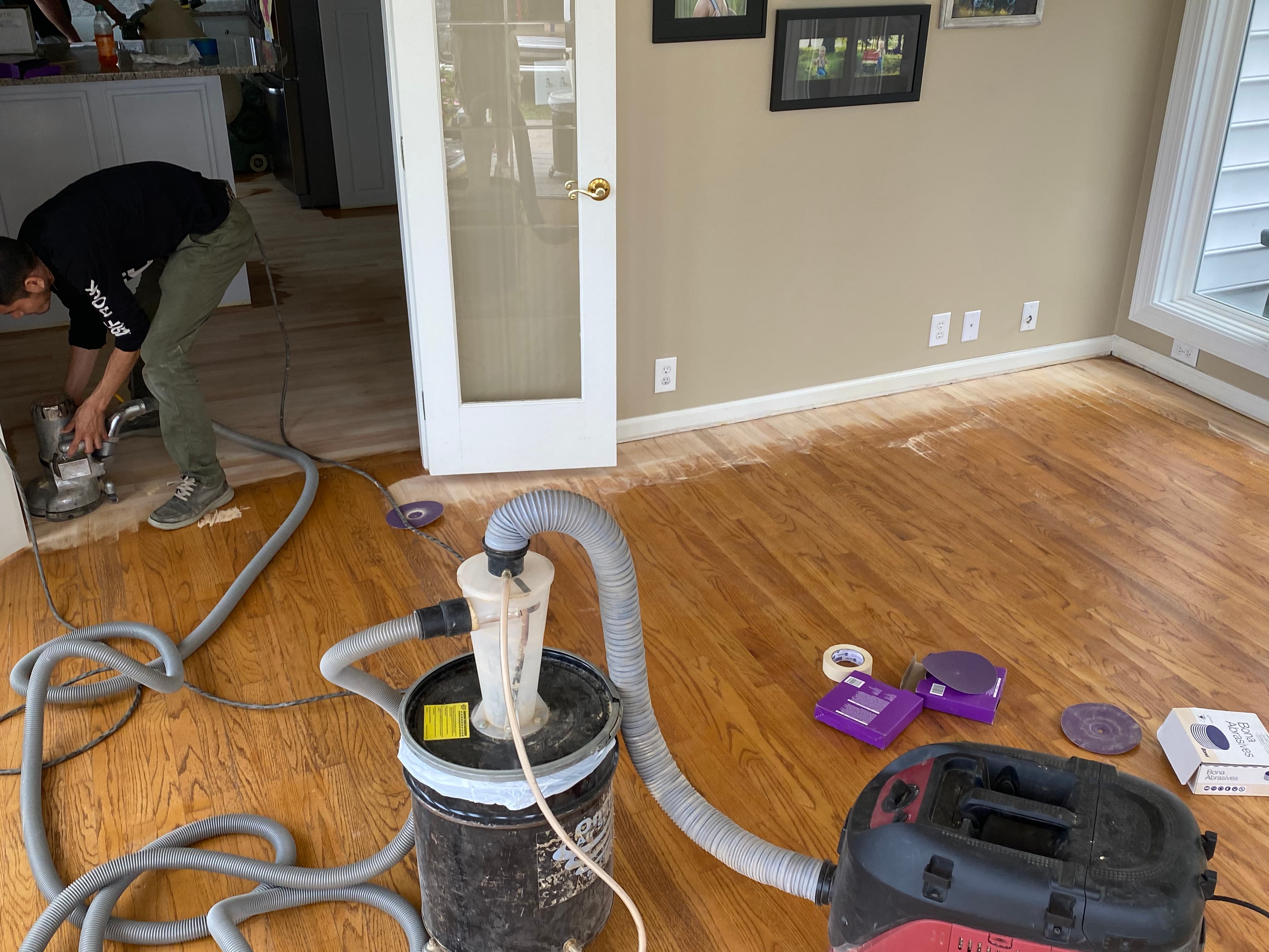 crew member edging hardwood floor during refinishing process Clayton NC