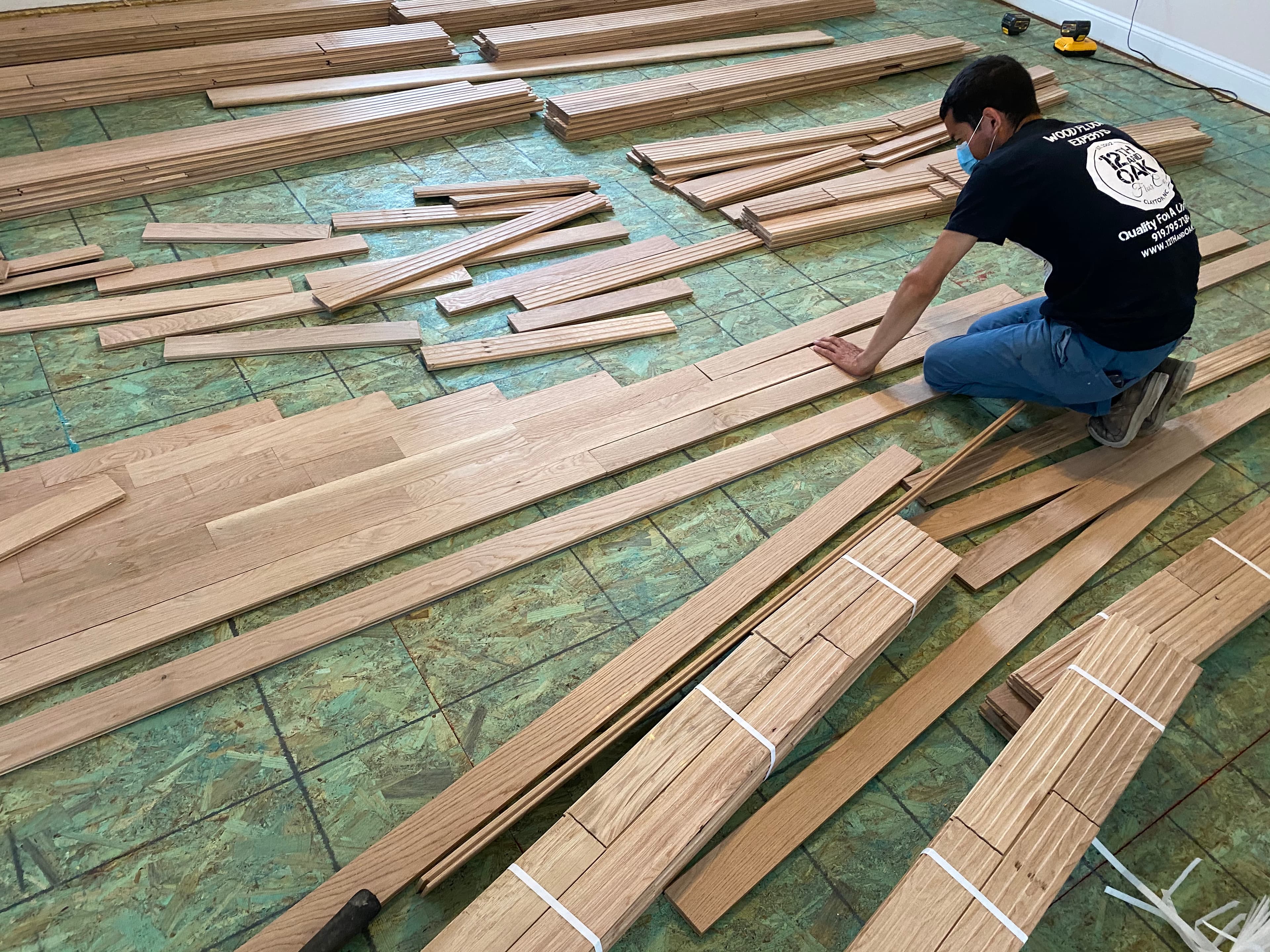 12th And Oak Floor Co crew laying out white oak boards before installation Clayton NC