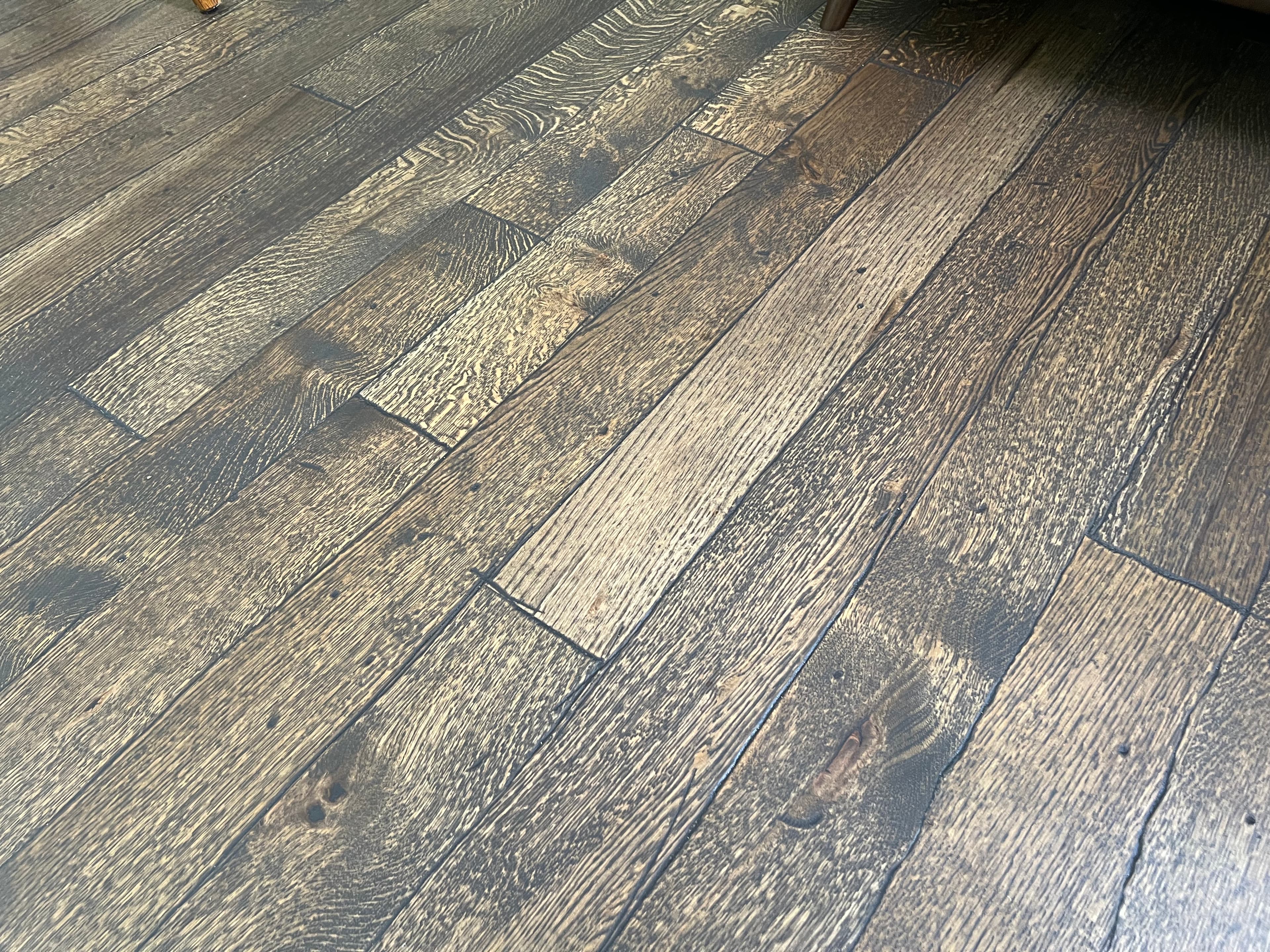 Dark stained wire-brushed white oak hardwood floors in Fuquay-Varina NC home by 12th And Oak Floor Co.