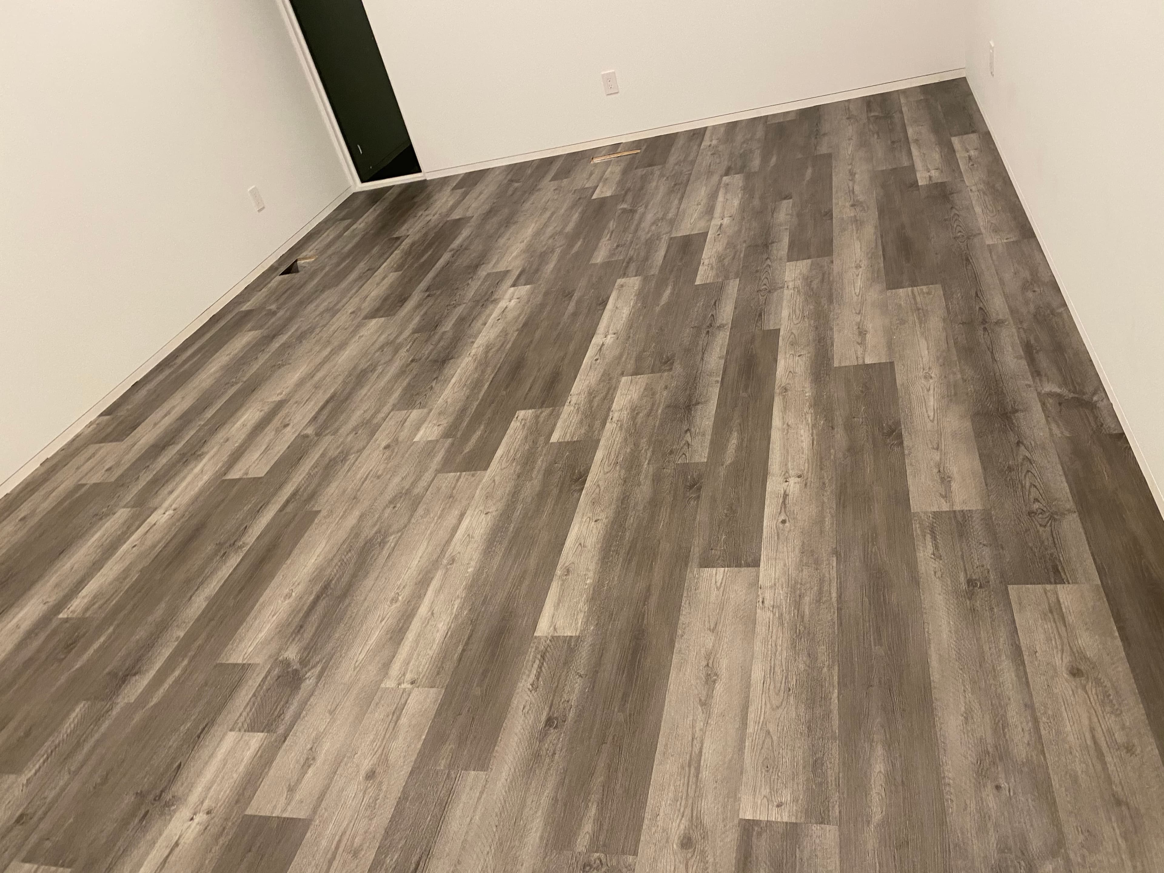 Laminate flooring installation in progress over underlayment by 12th And Oak Floor Co. Clayton NC