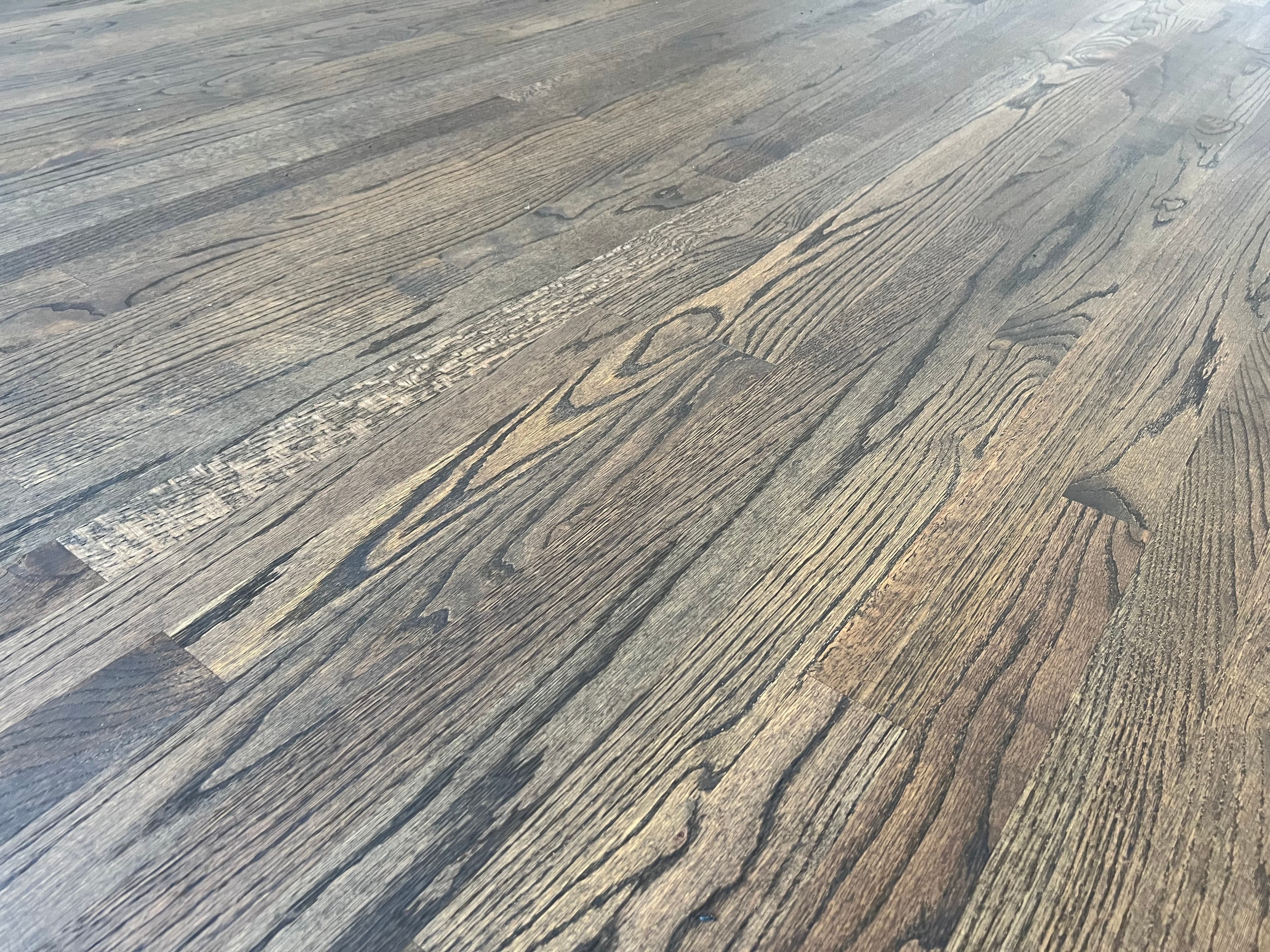 Low angle grain detail of finished red oak floor with custom hardwax oil blend in Austin Pond Clayton NC, dark dramatic tone showing open grain texture