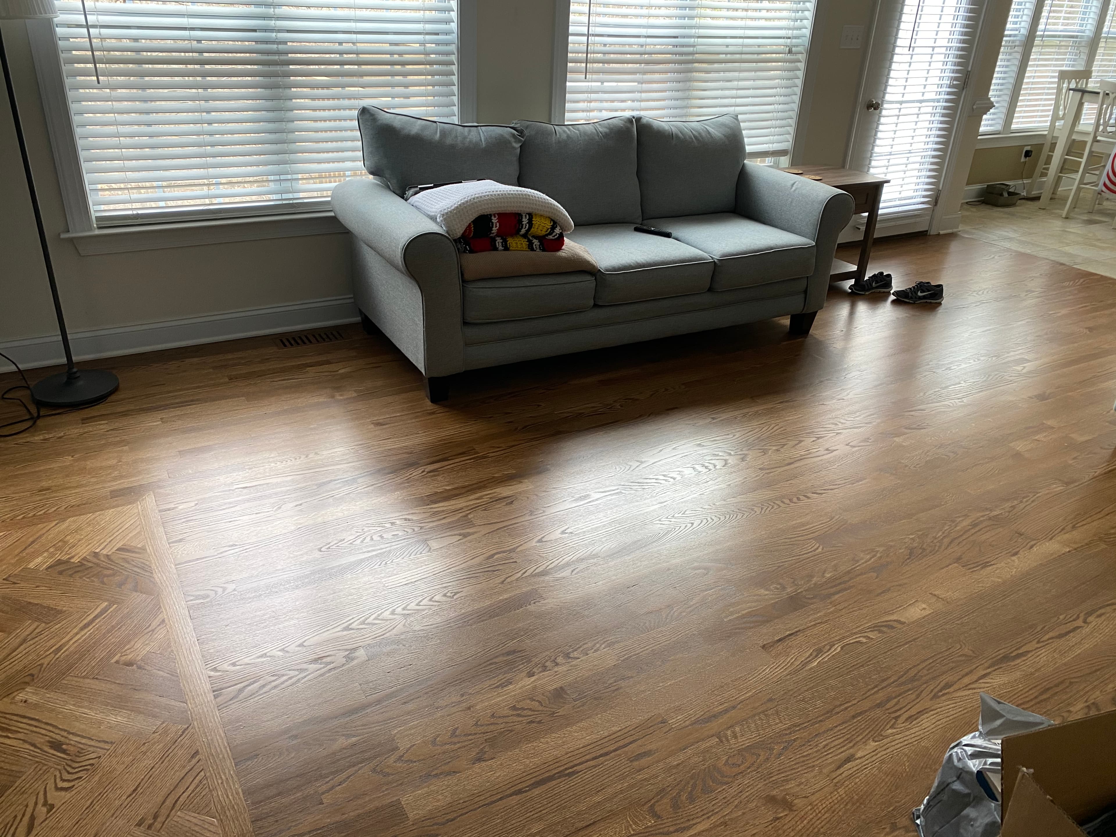 Red oak hardwood floors in furnished living room in Knightdale NC by 12th And Oak Floor Co.