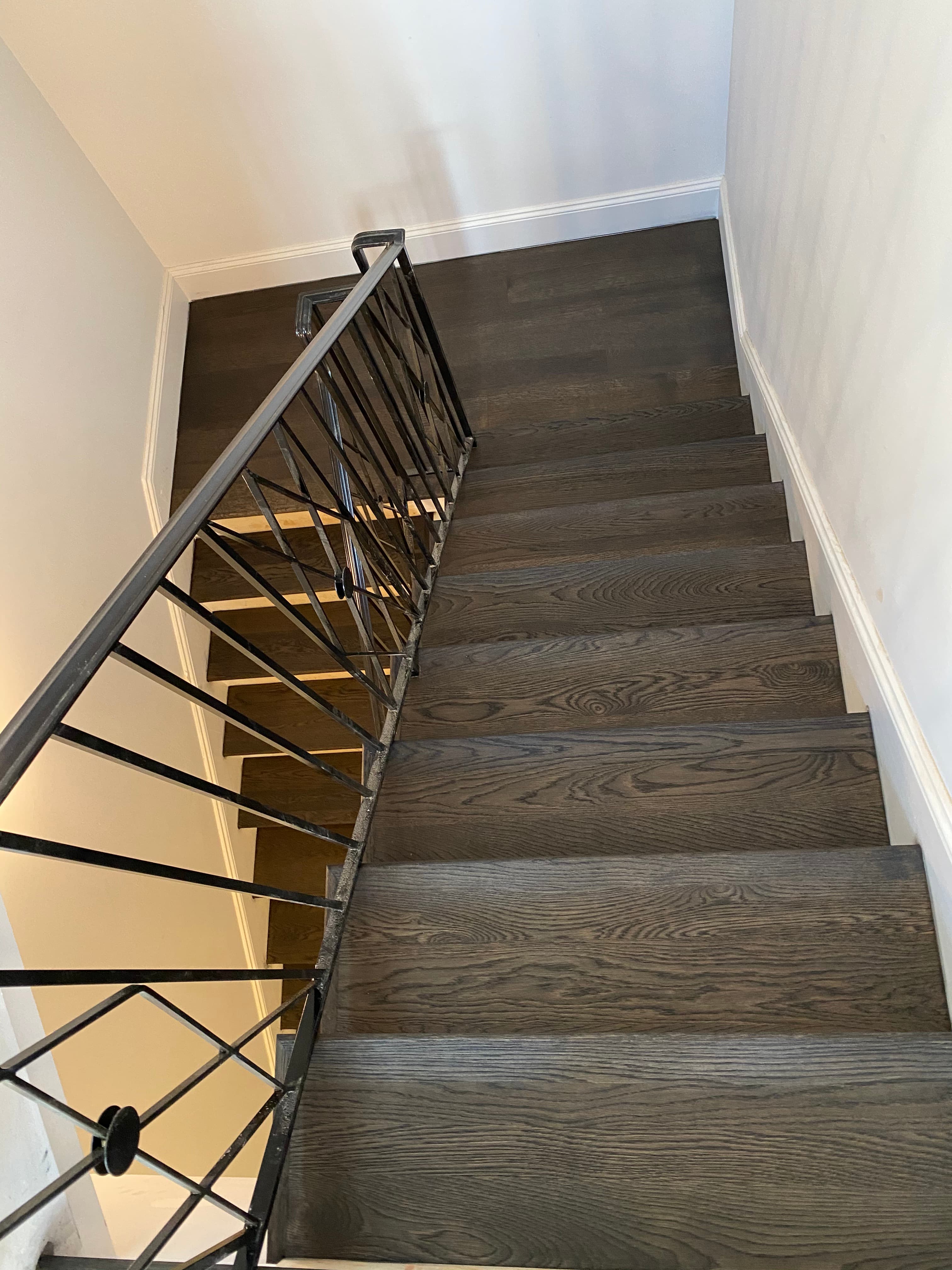 dark oak staircase remodeling with iron railing Clayton NC