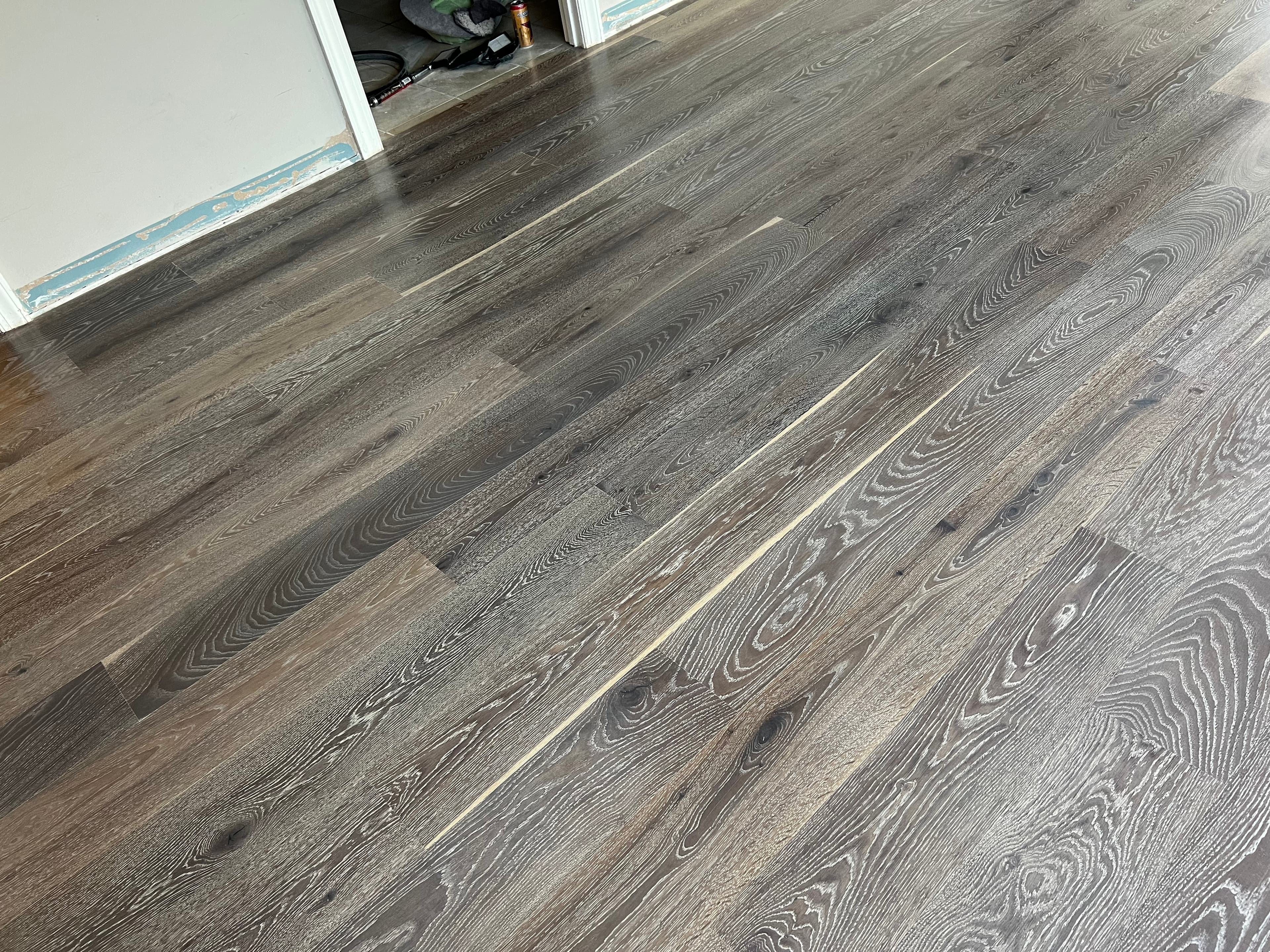 Wide plank white oak hardwood floors with cool gray stain installed in Cary NC home by 12th And Oak Floor Co.