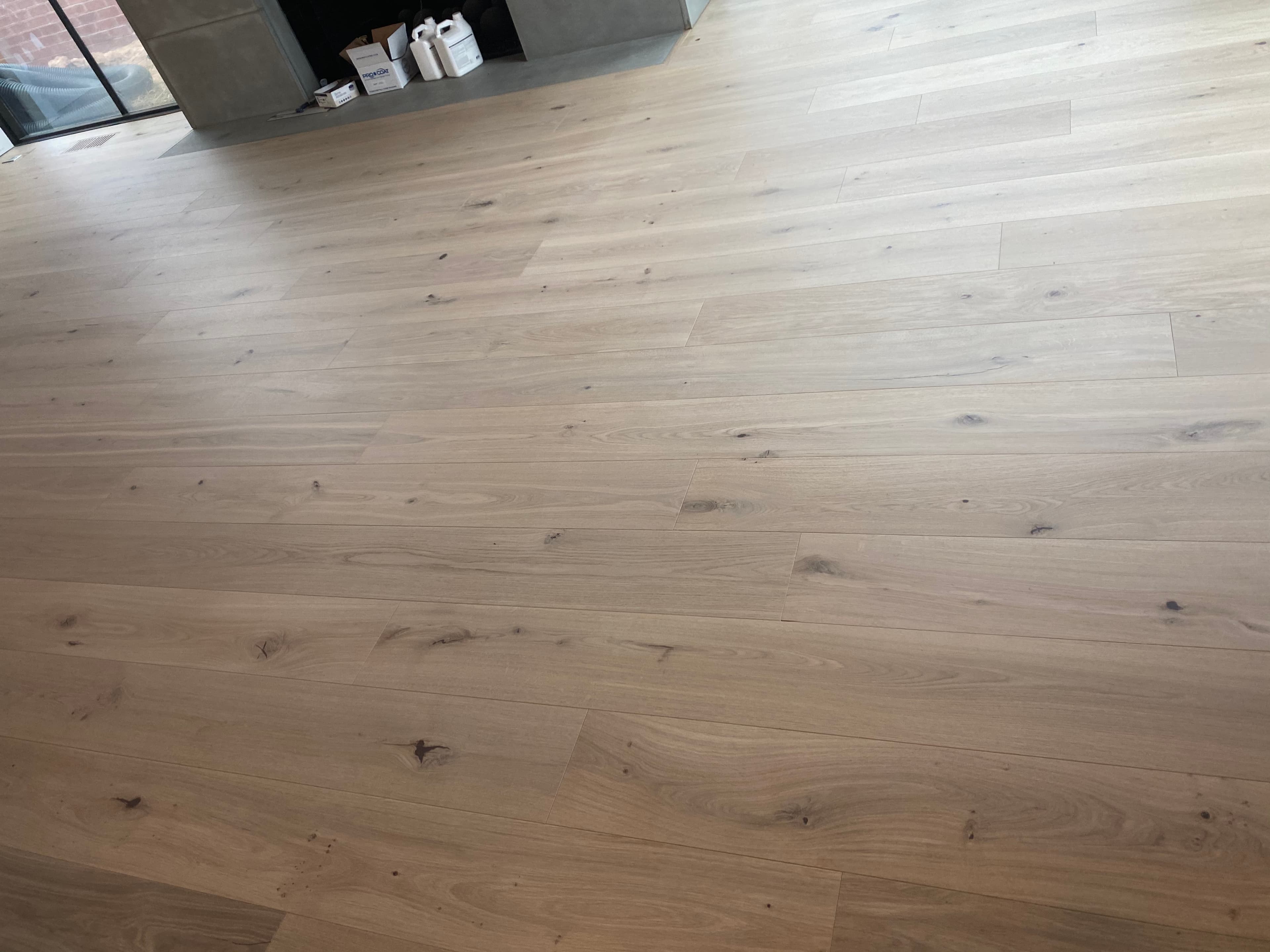 Wide plank white oak hardwood floor installation in Holly Springs NC home by 12th And Oak Floor Co.